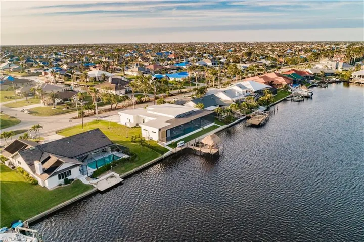 Aerial view of residential area featuring a nearby body of water