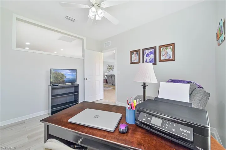 Living room with ceiling fan and light wood-type flooring