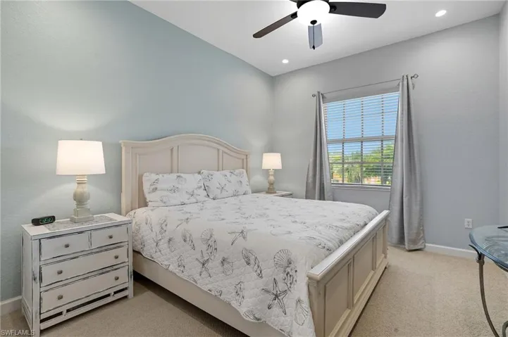 Bedroom with light carpet and ceiling fan