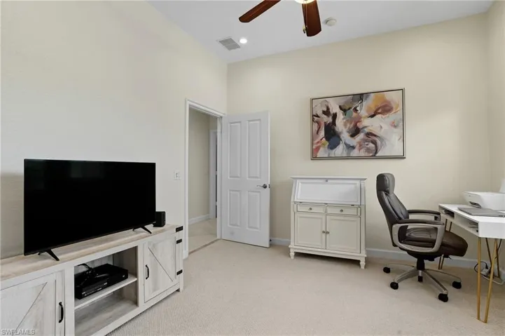 Home office with light carpet, ceiling fan, and recessed lighting