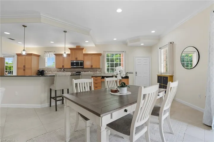 Dining room featuring crown molding, light tile patterned floors, and recessed lighting