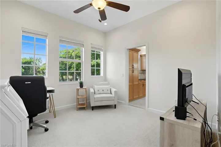 Office space featuring light carpet, ceiling fan, and recessed lighting