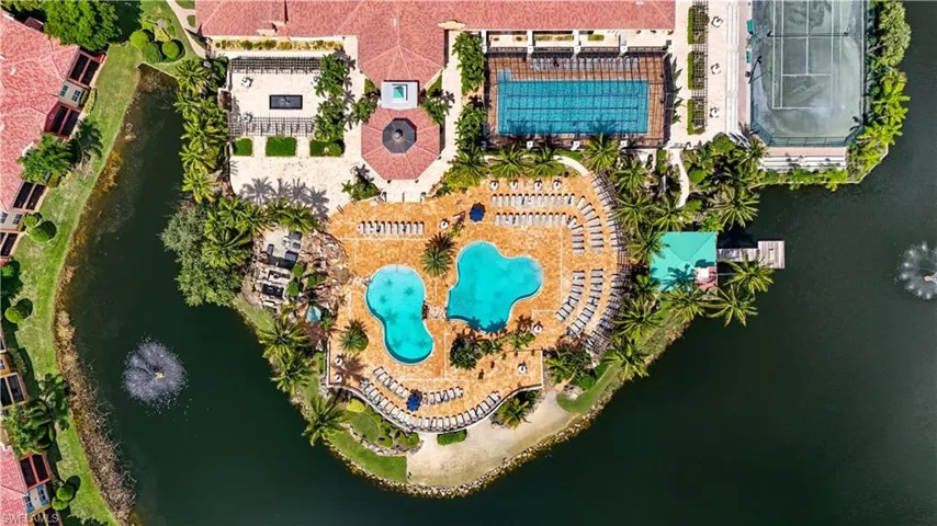 Aerial view of a pool and a nearby body of water