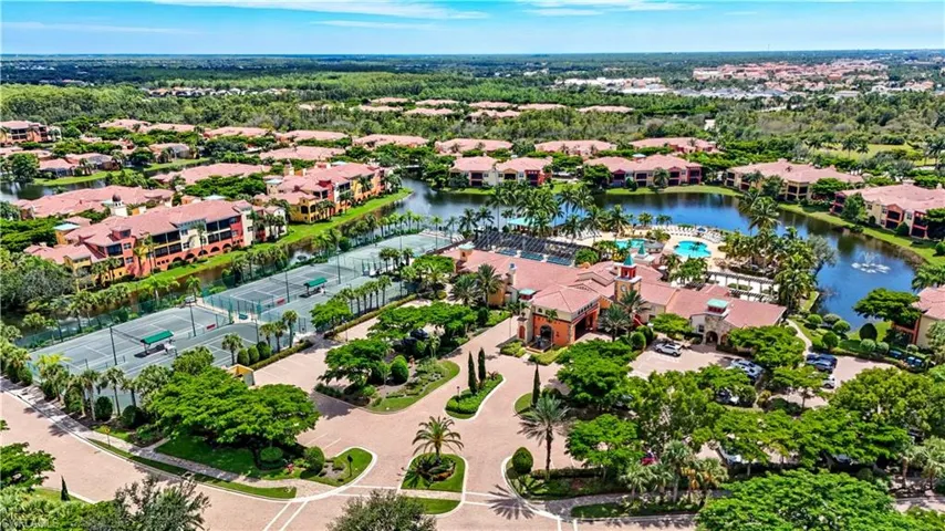 Aerial view of residential area featuring a nearby body of water