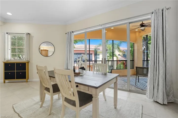 Dining room with light tile patterned floors, crown molding, ceiling fan, and recessed lighting
