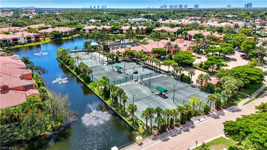Aerial view of residential area with a nearby body of water and city skyline