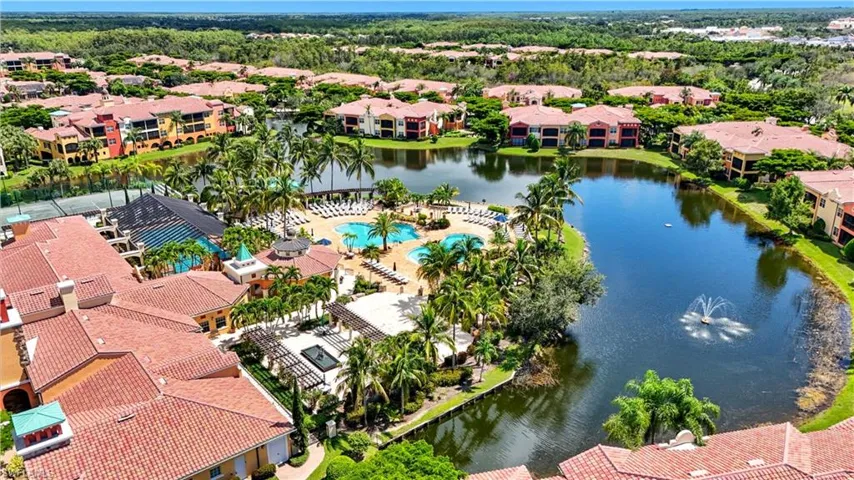 Aerial perspective of suburban area featuring a nearby body of water