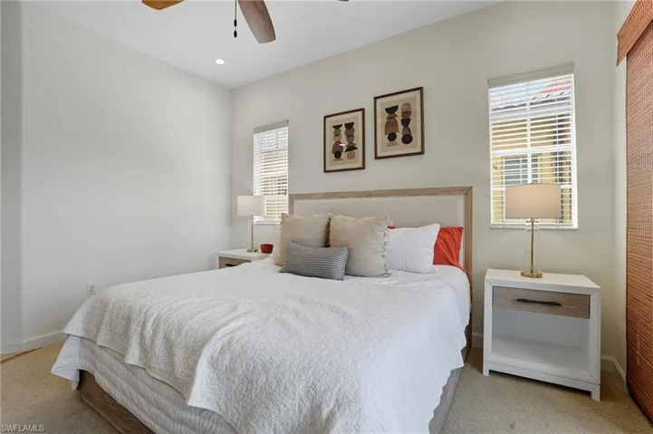 Bedroom featuring ceiling fan and light colored carpet