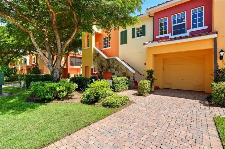 Mediterranean / spanish house featuring stucco siding, decorative driveway, a garage, and a front lawn
