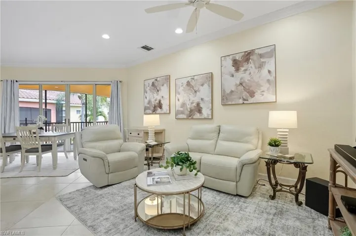 Living room featuring crown molding, recessed lighting, tile patterned floors, and a ceiling fan