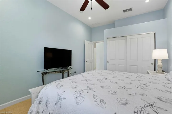 Bedroom featuring a closet, carpet flooring, a ceiling fan, and recessed lighting