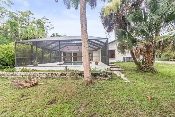 View of yard with a lanai