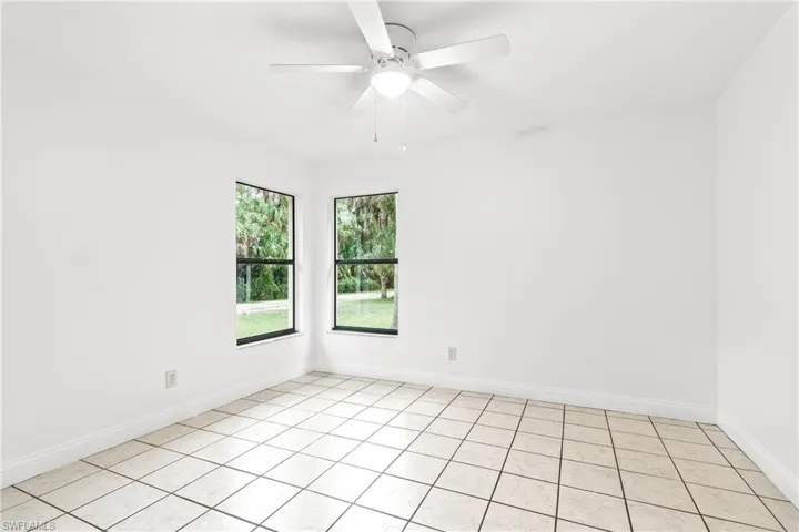 Tiled spare room with ceiling fan