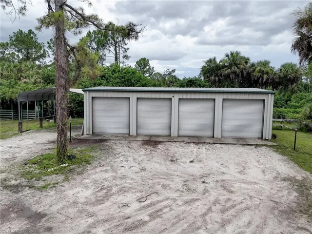 Garage featuring a carport