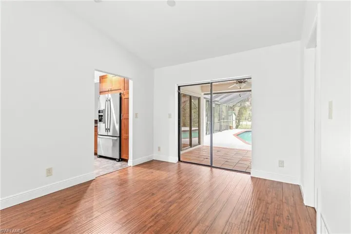Empty room featuring light hardwood / wood-style floors, lofted ceiling, and ceiling fan