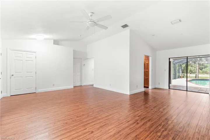 Unfurnished living room with high vaulted ceiling, ceiling fan, and light hardwood / wood-style floors
