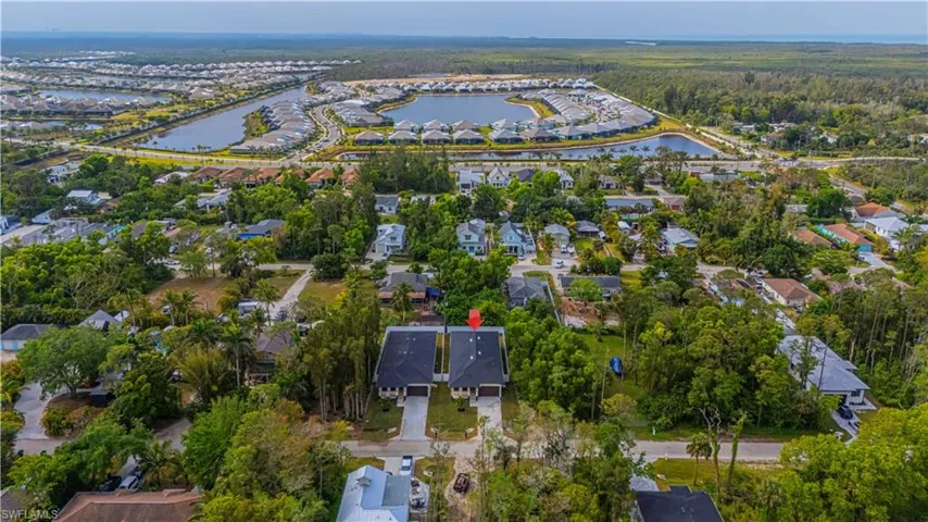 Birds eye view of property with a residential view and a water view