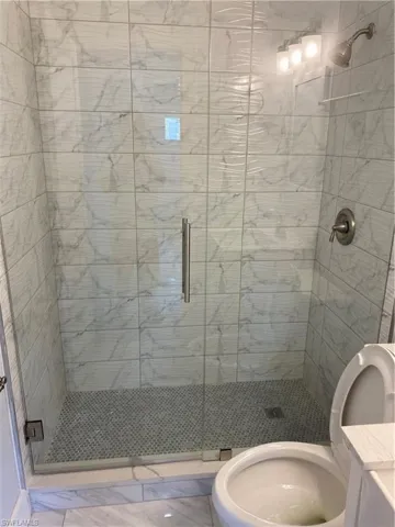 Full bath featuring a shower stall