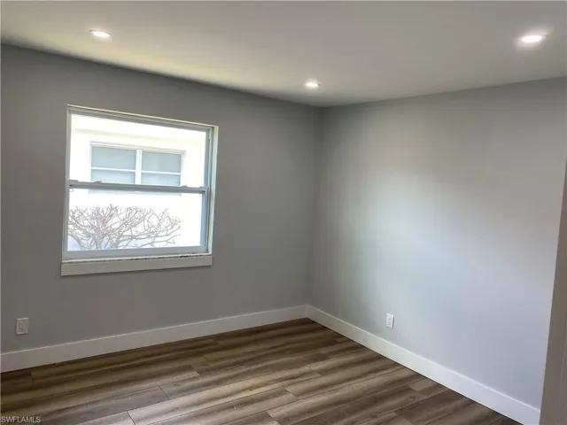 Spare room with dark wood-style flooring and recessed lighting