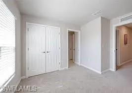 Unfurnished bedroom featuring a closet and baseboards