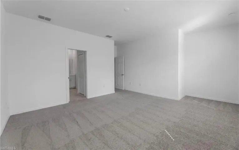 Unfurnished bedroom featuring light carpet