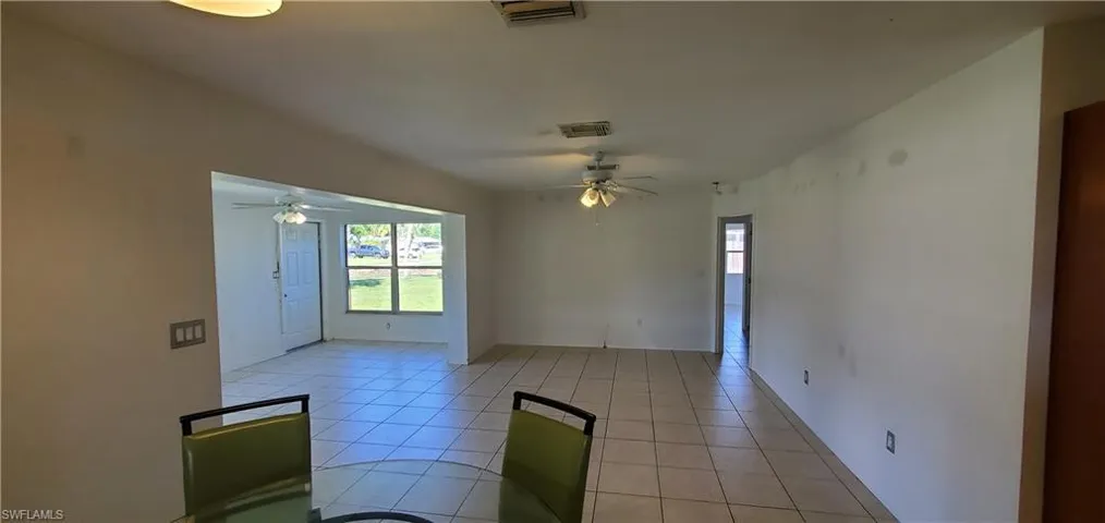 Tiled empty room featuring ceiling fan