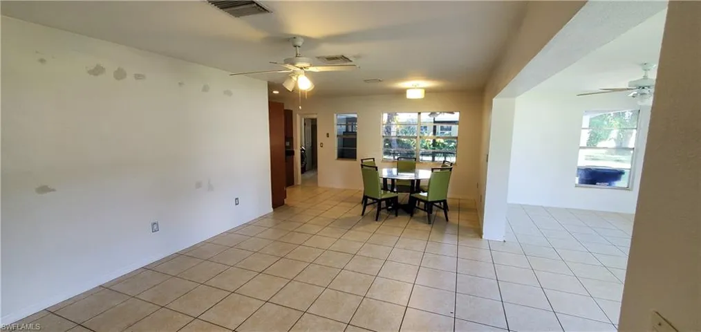 Tiled dining room with ceiling fan