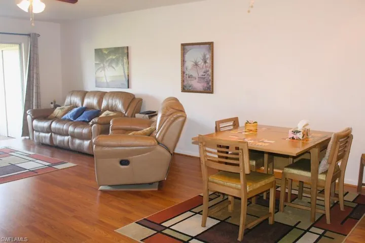 Living area with wood finished floors and ceiling fan