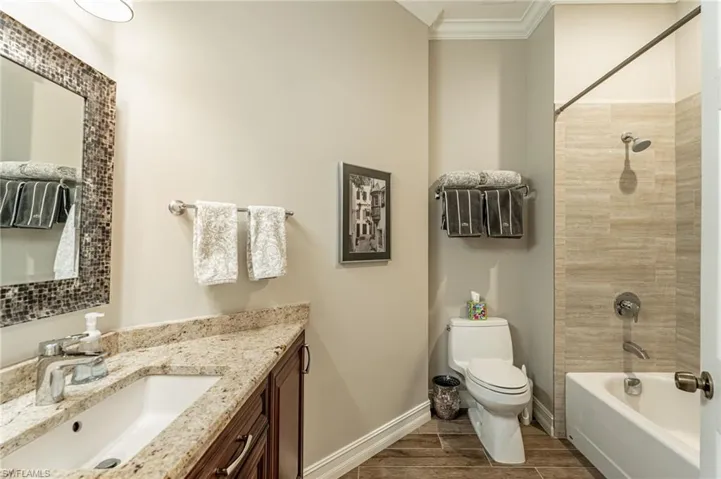 Same Guest bathroom with crown molding, picture, Kohler Toilet, tub & shower.