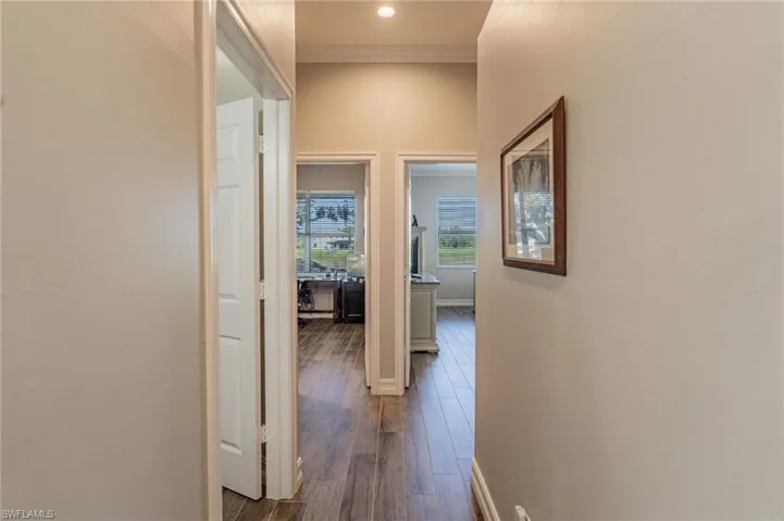 Hallway leading to the door on the left  for the guest bathroom, the den is a few steps further on left and the Master bedroom, bathroom and closet are on the right.