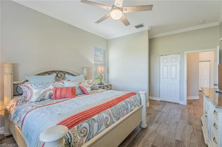 Master bedroom, window, fan, crown molding, closet door, hallway Porcelain floors.