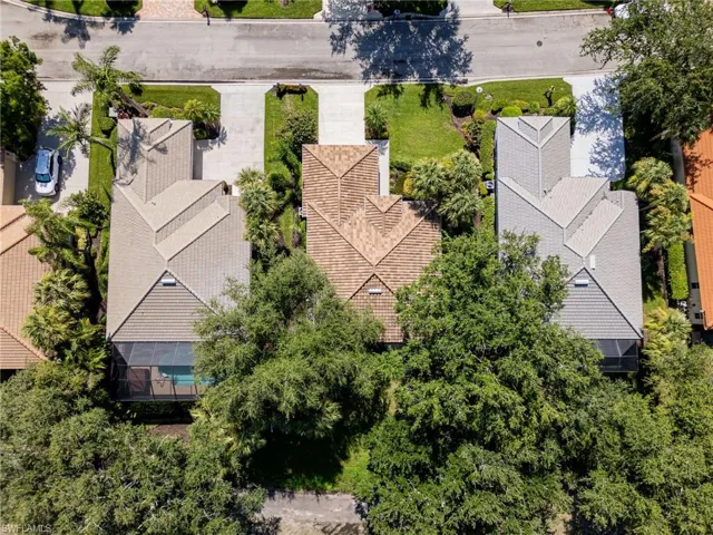 House is in the center of the picture,  Roof and trees on the back of the house.  Good protection for golf balls hit in that area.
