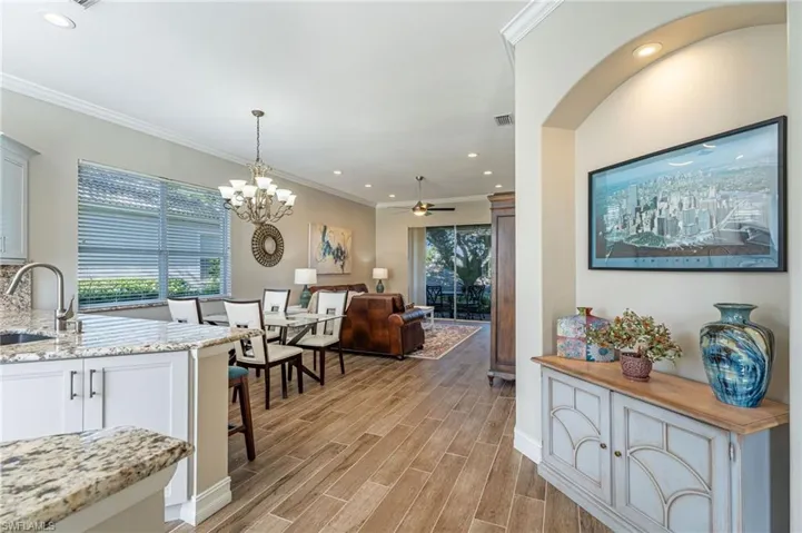 As you walk in the front door you are greeted by the picture on the right of the twin towers in New York. Looking back at the kitchen on the left, porcelain floors, granite counter tops and the dining room window with Granite to match under the window treatments.