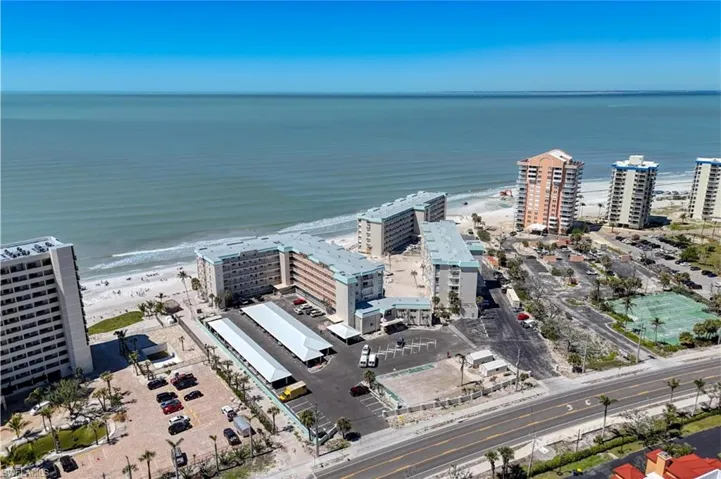 Bird's eye view featuring a water view, a view of city, and a view of the beach
