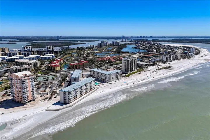 Drone / aerial view with a beach view and a water view