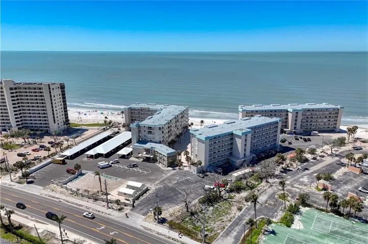 Drone / aerial view featuring a view of the beach, a view of city, and a water view