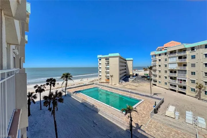 Pool featuring a beach view and a water view