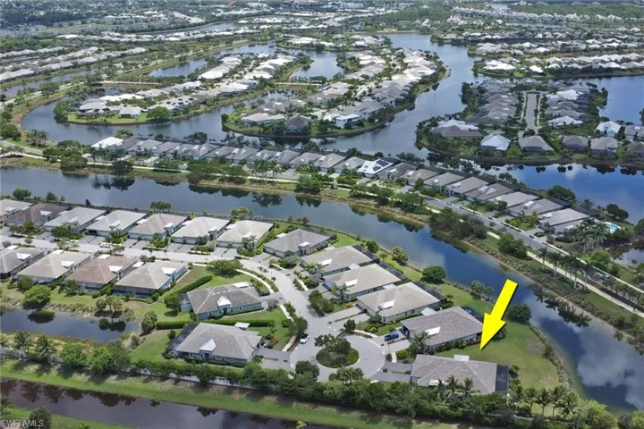 Aerial view of property and surrounding area with a large body of water and nearby suburban area