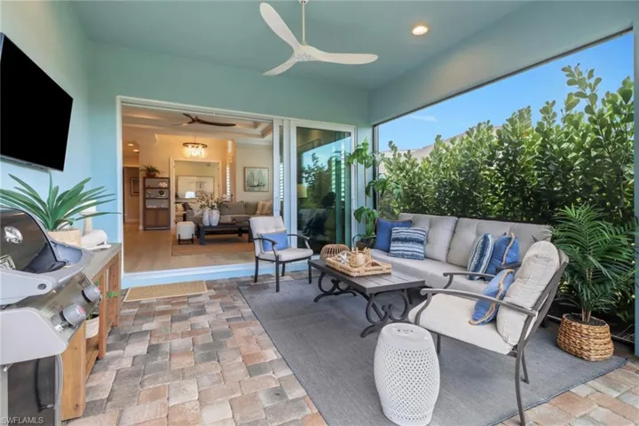 View of patio with an outdoor living space, grilling area, and ceiling fan