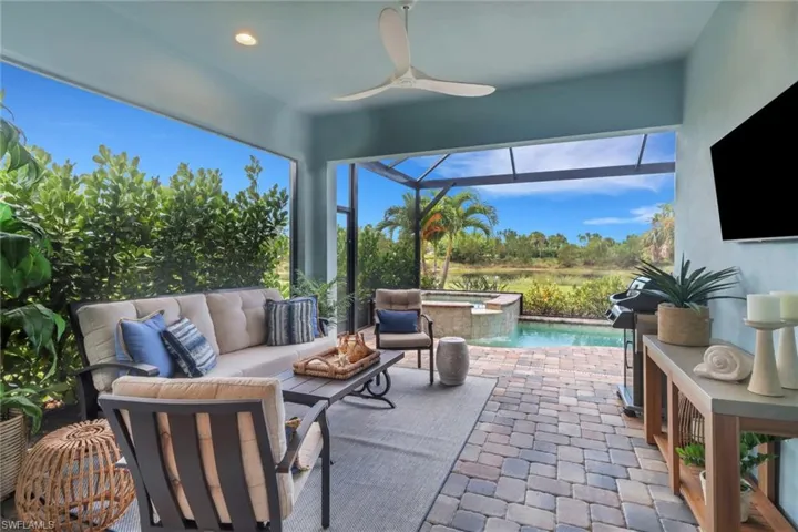 Sunroom with a ceiling fan, a jacuzzi, a patio area, and an outdoor hangout area
