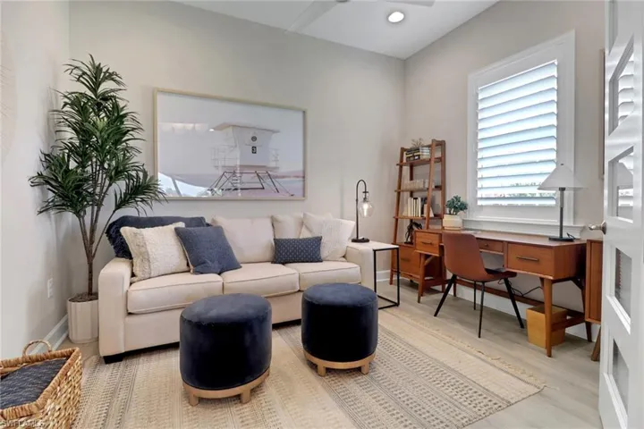 Office area featuring light wood-type flooring and recessed lighting