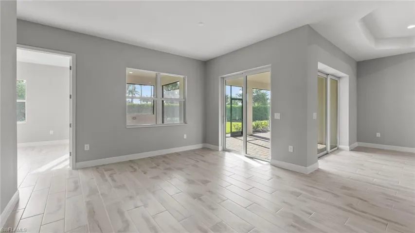 Empty room with a wealth of natural light and light hardwood / wood-style floors