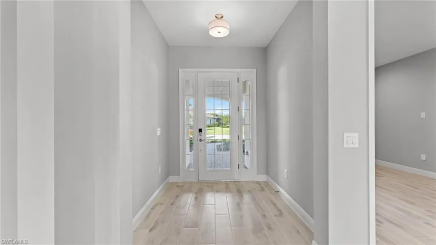 Entrance foyer with light hardwood / wood-style flooring