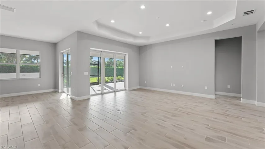 Unfurnished room with a tray ceiling