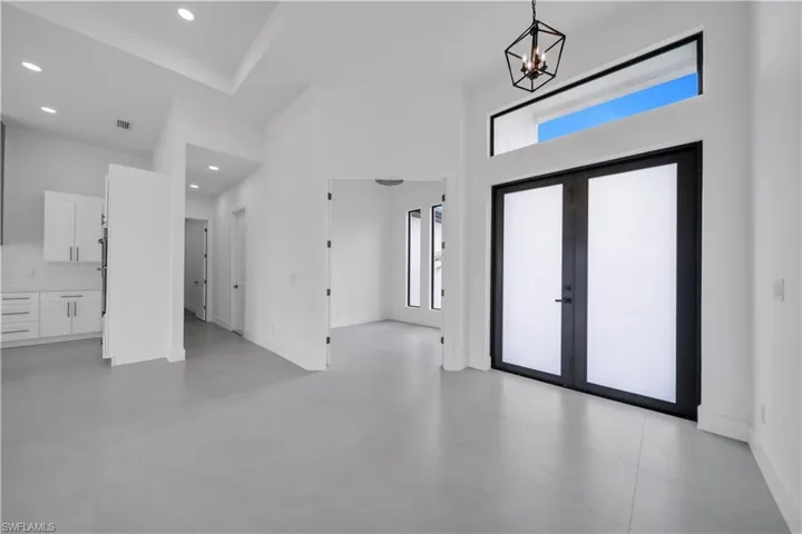 Entryway with recessed lighting and a chandelier
