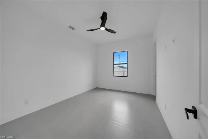 Spare room featuring baseboards and a ceiling fan