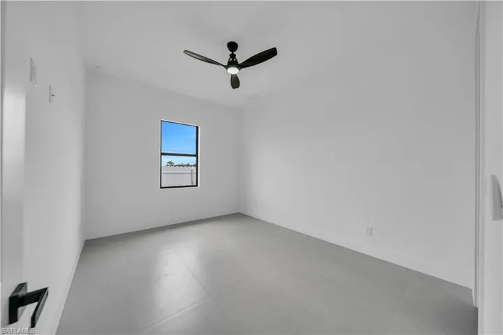 Unfurnished room with ceiling fan and baseboards