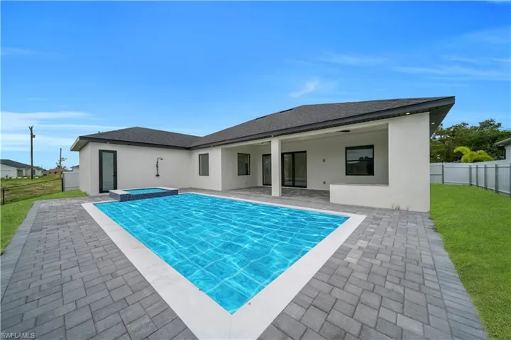 Back of property featuring a fenced backyard, a shingled roof, a patio area, and stucco siding