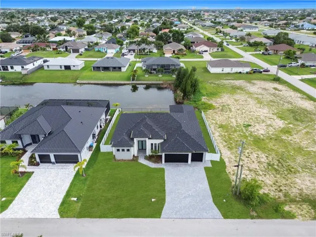 Aerial perspective of suburban area with a nearby body of water