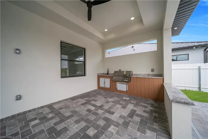 View of patio / terrace featuring area for grilling and ceiling fan